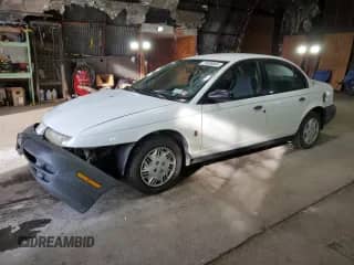 1999 Saturn SL with VIN 1G8ZH528XXZ235067, listed as a Copart auction lot 74508564 with 155,180 mi miles and Salvage title. Bid and sale history available at DreamBid. Image 1.
