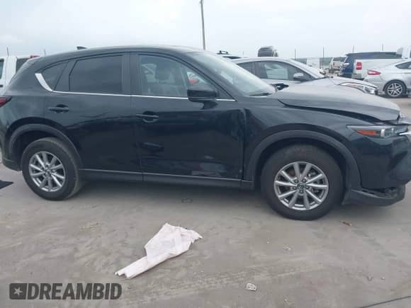 2023 Mazda CX-5 S Carbon Edition z VIN JM3KFBCM8P0202054, wystawiony jako IAAI lot #42392586 z przebiegiem 50 944 mil mil oraz . Historia ofert i sprzedaży dostępna na DreamBid. Obrazek 13.