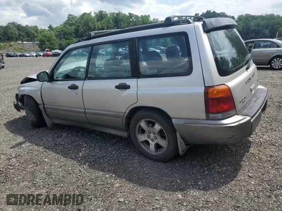 1999 Subaru Forester S with VIN JF1SF6557XH730701, listed as a Copart auction lot 65169235 with 142,246 mi miles and Salvage title. Bid and sale history available at DreamBid. Image 2.