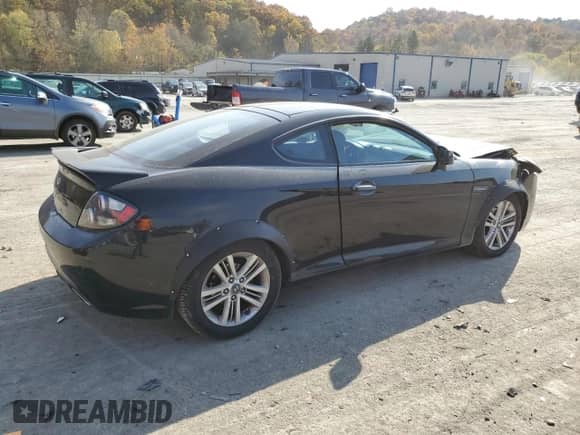 2007 Hyundai Tiburon GS with VIN KMHHM66D37U237424, listed as a Copart auction lot 77363534 with 160,018 mi miles and Salvage title. Bid and sale history available at DreamBid. Image 3.