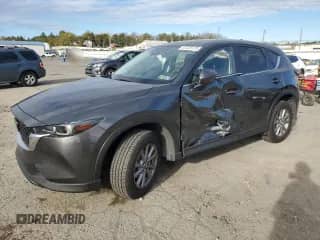 2022 Mazda CX-5 S Preferred z VIN JM3KFBCM9N0604873, wystawiony jako Copart lot #87225125 z przebiegiem 24 330 mil mil oraz Szkoda całkowita • Salvage title. Historia ofert i sprzedaży dostępna na DreamBid. Obrazek 1.