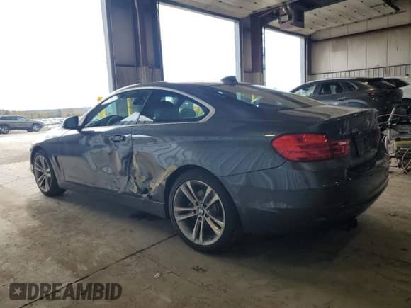 2016 BMW 4 Series 428i xDrive with VIN WBA3N9C54GK250699, listed as a Copart auction lot 87282015 with 94,742 mi miles and Salvage title. Bid and sale history available at DreamBid. Image 2.