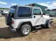 2000 Jeep Wrangler Sport z VIN 1J4FA49SXYP700513, wystawiony jako Copart lot #80155385 z przebiegiem 129 836 mil mil oraz Szkoda całkowita • Salvage title. Historia ofert i sprzedaży dostępna na DreamBid. Obrazek 3.