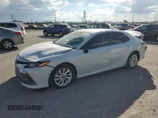 2023 Toyota Camry LE с VIN 4T1C11AK0PU152102, выставлен на аукционе Copart как лот 71174015 с пробегом 56 081 миль миль и Списание • Salvage title. История ставок и продаж доступна на DreamBid. Изображение 1.