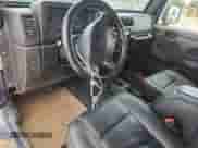 2003 Jeep Wrangler X z VIN 1J4FA39S33P356428, wystawiony jako Copart lot #70285135 z przebiegiem 147 788 mil mil oraz Szkoda całkowita • Salvage title. Historia ofert i sprzedaży dostępna na DreamBid. Obrazek 8.