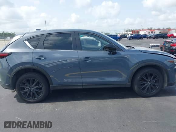 2023 Mazda CX-5 S Carbon Edition z VIN JM3KFBCM6P0171807, wystawiony jako IAAI lot #42450088 z przebiegiem 40 146 mil mil oraz . Historia ofert i sprzedaży dostępna na DreamBid. Obrazek 13.
