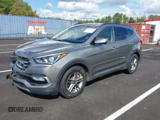 2018 Hyundai Santa Fe 2.4L z VIN 5NMZU3LBXJH098272, wystawiony jako IAAI lot #43375252 z przebiegiem 96 576 mil mil oraz . Historia ofert i sprzedaży dostępna na DreamBid. Obrazek 2.