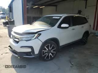 2020 Honda Pilot Touring 7-Passenger z VIN 5FNYF5H63LB011474, wystawiony jako Copart lot #62547135 z przebiegiem 100 676 mil mil oraz Szkoda całkowita • Salvage title. Historia ofert i sprzedaży dostępna na DreamBid. Obrazek 1.