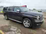 2015 Chevrolet Suburban LTZ z VIN 1GNSKKKC7FR254340, wystawiony jako Copart lot #82104195 z przebiegiem 152 947 mil mil oraz Szkoda całkowita • Salvage title. Historia ofert i sprzedaży dostępna na DreamBid. Obrazek 4.