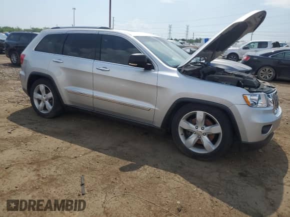 2011 Jeep Grand Cherokee Overland Summit with VIN 1J4RR6GTXBC536210, listed as a Copart auction lot 62634765 with 129,835 mi miles and Salvage title. Bid and sale history available at DreamBid. Image 4.