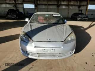 2007 Hyundai Tiburon GT с VIN KMHHN66F57U242154, выставлен на аукционе Copart как лот 85104284 с пробегом 122 242 миль миль и Чистый • Clean title. История ставок и продаж доступна на DreamBid. Изображение 5.