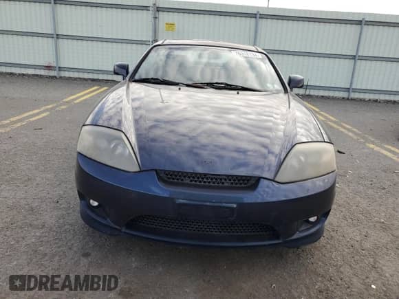 2005 Hyundai Tiburon GT с VIN KMHHN65F95U159244, выставлен на аукционе Copart как лот 76318134 с пробегом 78 324 миль миль и Чистый • Clean title. История ставок и продаж доступна на DreamBid. Изображение 5.