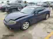 2003 Hyundai Tiburon GT with VIN KMHHN65F73U018847, listed as a Copart auction lot 58242385 with 164,976 mi miles and Salvage title. Bid and sale history available at DreamBid. Image 1.