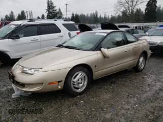 1997 Saturn SC with VIN 1G8ZG1279VZ308316, listed as a Copart auction lot 87381914 with 93,654 mi miles and Salvage title. Bid and sale history available at DreamBid. Image 1.