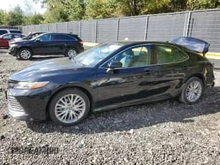 2018 Toyota Camry Hybrid XLE с VIN 4T1B21HK1JU506635, выставлен на аукционе Copart как лот 86139245 с пробегом 99 917 миль миль и Списание • Salvage title. История ставок и продаж доступна на DreamBid. Изображение 1.