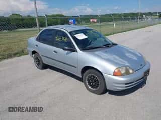 1999 Chevrolet Metro Lsi z VIN 2C1MR5222X6710860, wystawiony jako IAAI lot #42653198 z przebiegiem 75 087 mil mil oraz . Historia ofert i sprzedaży dostępna na DreamBid. Obrazek 1.