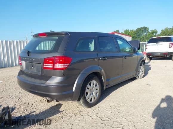 2015 Dodge Journey American Value z VIN 3C4PDCAB5FT559219, wystawiony jako IAAI lot #42852010 z przebiegiem 58 773 mil mil oraz . Historia ofert i sprzedaży dostępna na DreamBid. Obrazek 4.