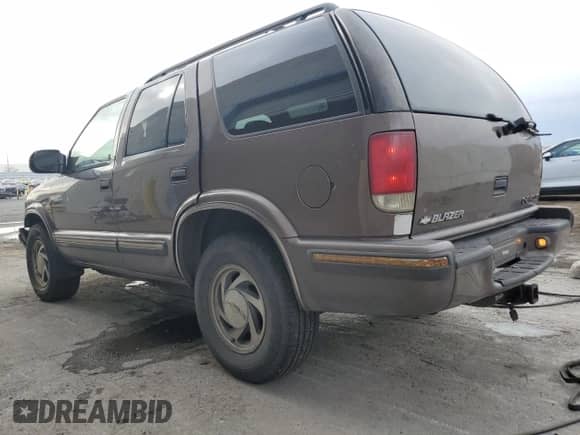 1999 Chevrolet Blazer LS with VIN 1GNDT13W3X2209981, listed as a Copart auction lot 84297504 with 226,641 mi miles and Salvage title. Bid and sale history available at DreamBid. Image 2.