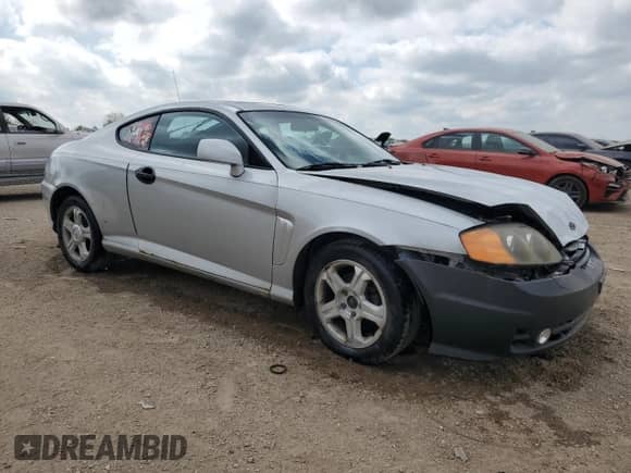 2003 Hyundai Tiburon with VIN KMHHM65D43U017995, listed as a Copart auction lot 56498665 with 162,820 mi miles and Salvage title. Bid and sale history available at DreamBid. Image 4.