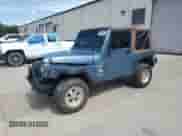 1998 Jeep Wrangler Sport z VIN 1J4FY19S1WP703520, wystawiony jako Copart lot #65905945 z przebiegiem 176 228 mil mil oraz Szkoda całkowita • Salvage title. Historia ofert i sprzedaży dostępna na DreamBid. Obrazek 1.