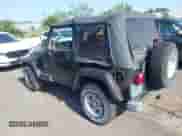 2002 Jeep Wrangler Sahara z VIN 1J4FA59S02P703627, wystawiony jako IAAI lot #42815504 z przebiegiem 144 573 mil mil oraz . Historia ofert i sprzedaży dostępna na DreamBid. Obrazek 3.
