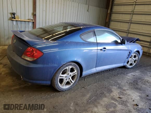 2005 Hyundai Tiburon GT с VIN KMHHN65F95U155274, выставлен на аукционе Copart как лот 46863235 с пробегом Не указан миль и Списание • Salvage title. История ставок и продаж доступна на DreamBid. Изображение 3.