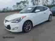 2014 Hyundai Veloster z VIN KMHTC6ADXEU213073, wystawiony jako IAAI lot #41551346 z przebiegiem 130 549 mil mil oraz . Historia ofert i sprzedaży dostępna na DreamBid. Obrazek 2.