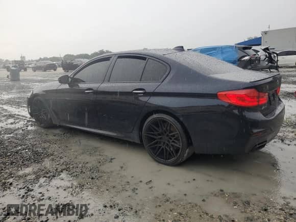 2018 BMW 5 Series M550i xDrive with VIN WBAJB9C54JB035699, listed as a Copart auction lot 71395105 with 94,373 mi miles and Salvage title. Bid and sale history available at DreamBid. Image 2.