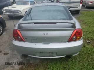 2003 Hyundai Tiburon GT с VIN KMHHN65F93U019840, выставлен на аукционе Copart как лот 74063394 с пробегом Не указан миль и На запчасти • Non repairable. История ставок и продаж доступна на DreamBid. Изображение 6.