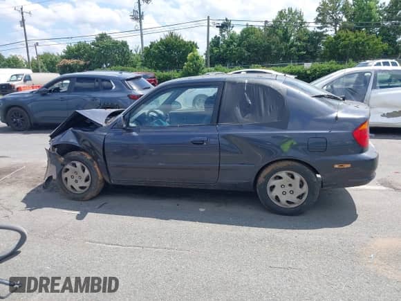 2005 Hyundai Accent GLS z VIN KMHCG35C35U366124, wystawiony jako IAAI lot #42552097 z przebiegiem 205 776 mil mil oraz . Historia ofert i sprzedaży dostępna na DreamBid. Obrazek 13.