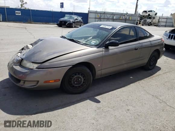 1999 Saturn SC with VIN 1G8ZN1288XZ310351, listed as a Copart auction lot 76677414 with Not provided miles and Salvage title. Bid and sale history available at DreamBid. Image 1.