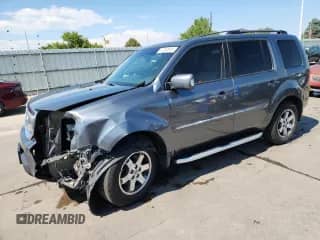 2010 Honda Pilot Touring with VIN 5FNYF4H84AB025991, listed as a Copart auction lot 71250615 with 121,648 mi miles and Salvage title. Bid and sale history available at DreamBid. Image 1.