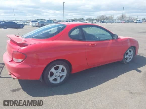 2001 Hyundai Tiburon z VIN KMHJG25F71U226180, wystawiony jako IAAI lot #42123872 z przebiegiem 167 444 mil mil oraz . Historia ofert i sprzedaży dostępna na DreamBid. Obrazek 4.