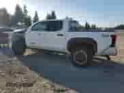 2025 Toyota Tacoma TRD Sport Hybrid with VIN 3TYLC5LN6ST020699, listed as a Copart auction lot 82133585 with 3,277 mi miles and Salvage title. Bid and sale history available at DreamBid. Image 2.