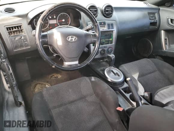 2004 Hyundai Tiburon GT с VIN KMHHN65F74U129996, выставлен на аукционе Copart как лот 43359015 с пробегом 231 277 миль миль и Списание • Salvage title. История ставок и продаж доступна на DreamBid. Изображение 8.