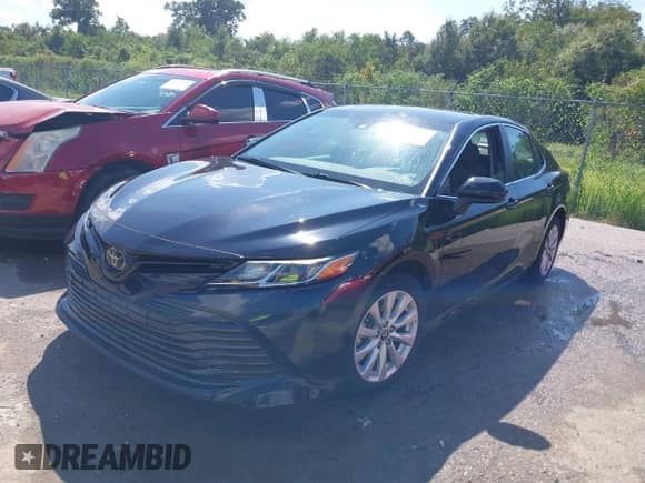 2020 Toyota Camry LE with VIN 4T1C11AKXLU877796, listed as a IAAI auction lot 43384594 with 78,546 mi miles and . Bid and sale history available at DreamBid. Image 2.