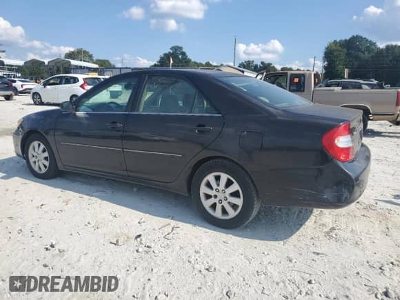 2003 Toyota Camry XLE с VIN 4T1BE30K33U181715, выставлен на аукционе Copart как лот 71077945 с пробегом 233 892 миль миль и Списание • Salvage title. История ставок и продаж доступна на DreamBid. Изображение 2.