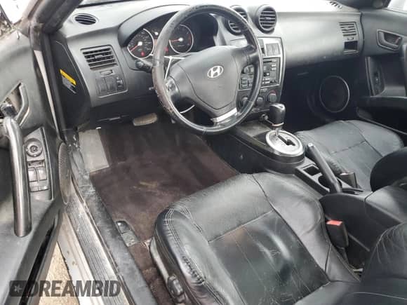 2003 Hyundai Tiburon GT с VIN KMHHN65F13U013420, выставлен на аукционе Copart как лот 51234495 с пробегом 230 612 миль миль и Списание • Salvage title. История ставок и продаж доступна на DreamBid. Изображение 8.