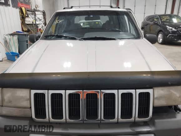 1996 Jeep Grand Cherokee Laredo z VIN 1J4GZ58S5TC293897, wystawiony jako IAAI lot #42435233 z przebiegiem 167 432 mil mil oraz . Historia ofert i sprzedaży dostępna na DreamBid. Obrazek 12.