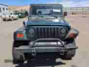 2002 Jeep Wrangler X z VIN 1J4FA39S22P776339, wystawiony jako Copart lot #57907165 z przebiegiem 154 088 mil mil oraz Szkoda całkowita • Salvage title. Historia ofert i sprzedaży dostępna na DreamBid. Obrazek 5.