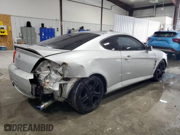 2006 Hyundai Tiburon GT с VIN KMHHN65F96U203924, выставлен на аукционе Copart как лот 43624185 с пробегом 120 403 миль миль и Списание • Salvage title. История ставок и продаж доступна на DreamBid. Изображение 3.