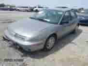 1999 Saturn SL z VIN 1G8ZK5275XZ165082, wystawiony jako IAAI lot #41939970 z przebiegiem 102 694 mil mil oraz . Historia ofert i sprzedaży dostępna na DreamBid. Obrazek 2.