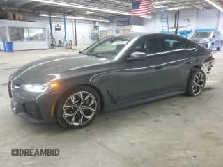 2024 BMW i4 eDrive40 with VIN WBY73AW03RFR57329, listed as a Copart auction lot 61002235 with 20,243 mi miles and Salvage title. Bid and sale history available at DreamBid. Image 1.