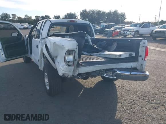 2002 Dodge Dakota SLT with VIN 1B7HL48NX2S518299, listed as a IAAI auction lot 41414659 with 220,943 mi miles and . Bid and sale history available at DreamBid. Image 6.