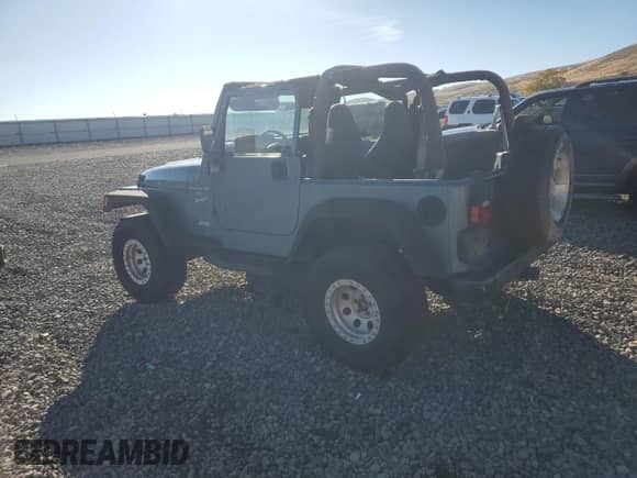 1999 Jeep Wrangler Sport with VIN 1J4FY19S1XP455674, listed as a Copart auction lot 86821605 with 218,356 mi miles and Clean title. Bid and sale history available at DreamBid. Image 2.