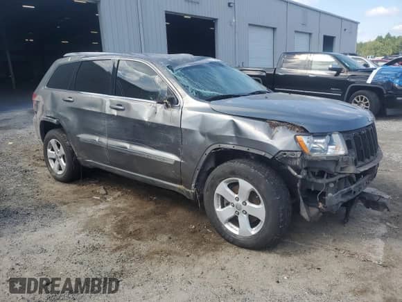 2011 Jeep Grand Cherokee Laredo with VIN 1J4RS4GG7BC580175, listed as a Copart auction lot 71319395 with 228,987 mi miles and Salvage title. Bid and sale history available at DreamBid. Image 4.
