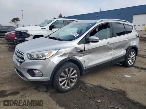 2017 Ford Escape Titanium z VIN 1FMCU9J96HUA60318, wystawiony jako Copart lot #81302185 z przebiegiem 107 623 mil mil oraz Czysty tytuł • Clean title. Historia ofert i sprzedaży dostępna na DreamBid. Obrazek 1.