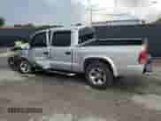 2003 Dodge Dakota Sport с VIN 1D7HL38N63S188341, выставлен на аукционе Copart как лот 61622355 с пробегом 102 433 миль миль и Списание • Salvage title. История ставок и продаж доступна на DreamBid. Изображение 2.