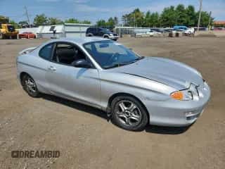2001 Hyundai Tiburon с VIN KMHJG25FX1U237982, выставлен на аукционе Copart как лот 65774595 с пробегом 125 241 миль миль и Списание • Salvage title. История ставок и продаж доступна на DreamBid. Изображение 4.