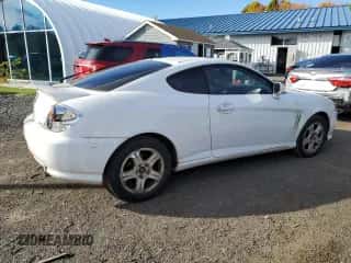 2003 Hyundai Tiburon GT с VIN KMHHN65FX3U096958, выставлен на аукционе Copart как лот 75451144 с пробегом 200 579 миль миль и Списание • Salvage title. История ставок и продаж доступна на DreamBid. Изображение 3.